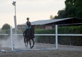 Young girl with helmet trains horseback riding Royalty Free Stock Photo