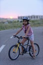 Young girl and her bicycle in road Royalty Free Stock Photo