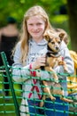 A young girl with her dog in the park at a Dog Show.