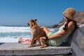 Young girl with her dog watching the sea Royalty Free Stock Photo