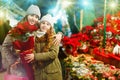 Young girl and her mother are buying Christmas ornamentals in th