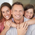 The best team hes ever rooted for. A young girl with her parents spending time indoors. Royalty Free Stock Photo