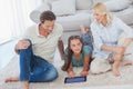 Young girl and her parents using a tablet Royalty Free Stock Photo