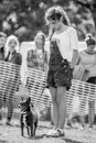 A young girl with her puppy the park at a dog show.