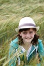 A young girl hiding in a corn field