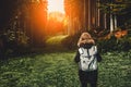 Young girl hiker at sunset mountains landscape with backpack travel. Lifestyle wanderlust adventure Royalty Free Stock Photo