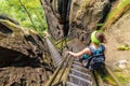 Girl hiking on steep stairs in Bohemian-Saxon Switzerland hiking area, Germany