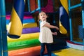 Young girl hitting foam object in play gym