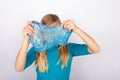 Young girl holdin a transparend blue glitter slime in front of her face Royalty Free Stock Photo