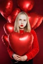 Young girl holding balloons red heart. Valentines people and Valentine`s day concept Royalty Free Stock Photo