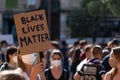 young girl holding a banner during demonstration against racism. Black lives matter message