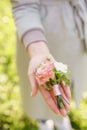 Boutonniere. Young girl holding a beautiful spring Flowers. flower arrangement with lisianthus. Color light pink. Bright