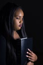 Young Girl Holding Bible Close To Her Heart