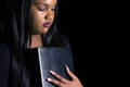 Young Girl Holding Bible Close To Her Heart