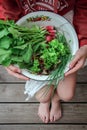 Young girl holding a bowl with the garden harvest Royalty Free Stock Photo