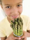 Young girl holding bunch of asparagus Royalty Free Stock Photo