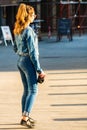 Young girl holding a camera on the streets of Bucharest, Romania, 2019