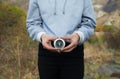 Young girl holding a compass in her hand. He is in the high mountains Royalty Free Stock Photo