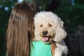 Young girl holding dog