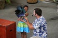 Young girl holding exotic bird during live show,Jungle Island,Miami,2014 Royalty Free Stock Photo