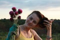 A young girl holding a flower - milk thistle, bouquet Royalty Free Stock Photo