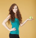 Young girl holding a green apple smiling Royalty Free Stock Photo