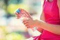 Young girl holding in hand bottle water on a hot summer day Royalty Free Stock Photo