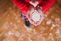 young girl holding with hands artificial snow flakes at home. Christmas concept