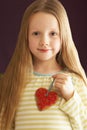 Young Girl Holding Heart Shaped Cookie In Studio Royalty Free Stock Photo