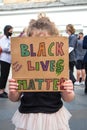 Young girl holding a homemade placard for Black Lives Matter at a rally demonstration