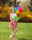 Young girl holding large Flower shaped wind wheel