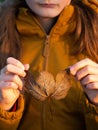 Young girl holding leaf covered with frost. Royalty Free Stock Photo