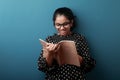 Young girl holding note book and reading it Royalty Free Stock Photo