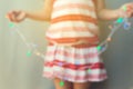 Young Girl Holding Out Of Focus Christmas Lights. Christmas Holiday Background