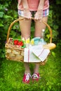 Young girl holding a picnic basket with food Royalty Free Stock Photo