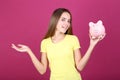 Girl holding pink piggybank Royalty Free Stock Photo