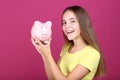 Girl holding pink piggybank Royalty Free Stock Photo