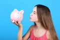 Girl holding pink piggybank Royalty Free Stock Photo