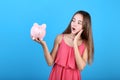 Girl holding pink piggybank Royalty Free Stock Photo