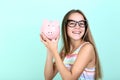 Girl holding pink piggybank Royalty Free Stock Photo