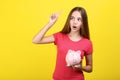 Girl holding pink piggybank Royalty Free Stock Photo