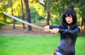 Young girl holding samurai sword. Royalty Free Stock Photo