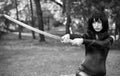 Young girl holding samurai sword. Royalty Free Stock Photo