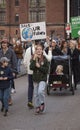 Young girl holding a sign reading Save Our Future with a cartoon drawing of the Earth Royalty Free Stock Photo