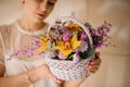 Young girl holding a spring white basket of tender yellow orchids