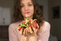 Young girl is holding two fresh ripe organic dragon fruits or pitaya, pitahaya. Exotic fruits, healthy eating concept Royalty Free Stock Photo