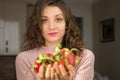 Young girl is holding two fresh ripe organic dragon fruits or pitaya, pitahaya. Exotic fruits, healthy eating concept Royalty Free Stock Photo