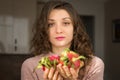 Young girl is holding two fresh ripe organic dragon fruits or pitaya, pitahaya. Exotic fruits, healthy eating concept Royalty Free Stock Photo