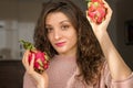 Young girl is holding two fresh ripe organic dragon fruits or pitaya, pitahaya. Exotic fruits, healthy eating concept Royalty Free Stock Photo