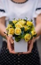 Young girl, holding vase with fresh spring flowers Royalty Free Stock Photo